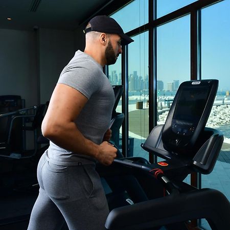 Mina Hotel And Residences By The Torch Доха Екстериор снимка A man exercising on a treadmill