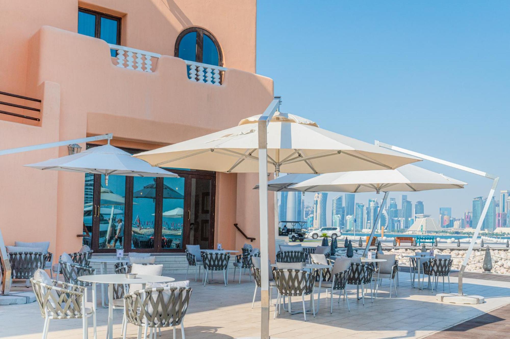 Mina Hotel And Residences By The Torch Доха Екстериор снимка A patio umbrella